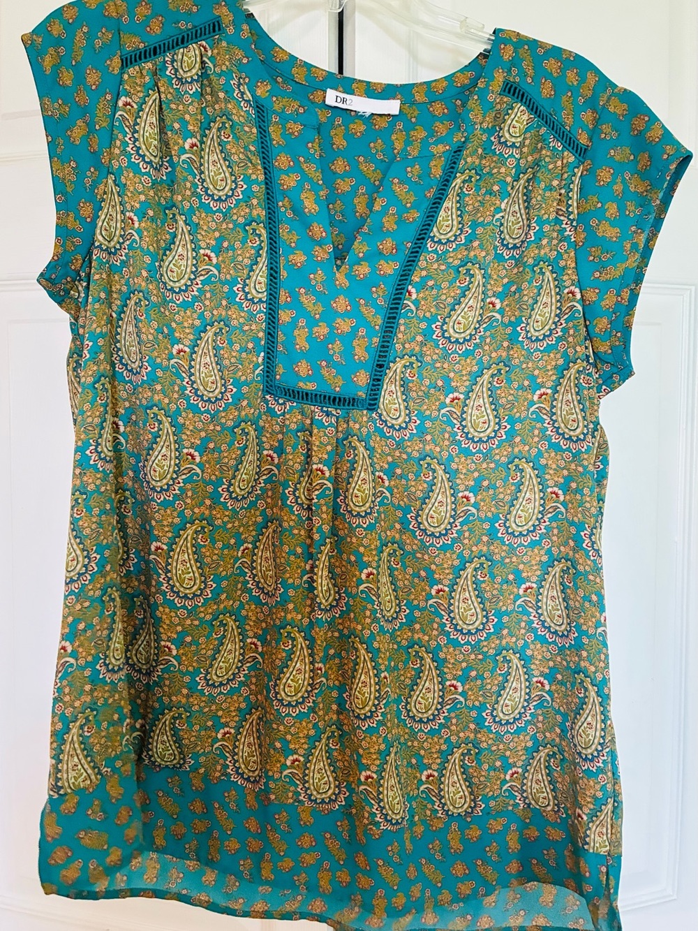 Women's sleeveless summer top. Brilliant colors in paisley design.